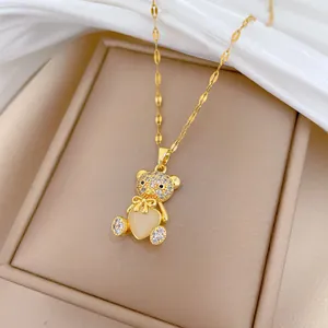 Macro view of teddy bear pendant featuring heart-shaped opal and crystal micro-paving
