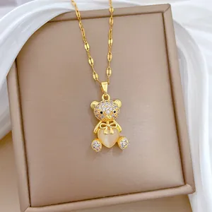 Macro shot of bear pendant necklace with heart cat eye stone and pave crystals