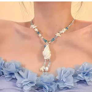 Elegant summer seaside style necklace featuring blue beads and white shell starfish charms