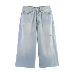Light blue distressed denim wide-leg shorts with raw hem and ripped details