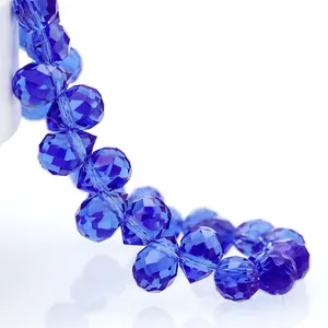 Macro view of teardrop deep blue faceted crystal glass beads with precise light reflection