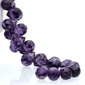 Macro shot of faceted dark purple K9 crystal teardrop beads with high clarity and sparkle