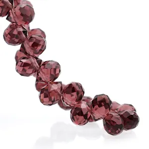 Macro shot of faceted dark purple crystal beads with sparkling light reflection details