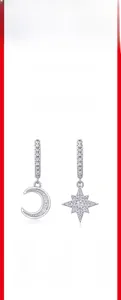 Detail of S925 silver moon and star earrings featuring pave set moissanite stones