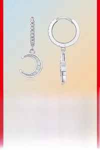 Detailed close-up of S925 sterling silver moon drop earrings with sparkling moissanite stones