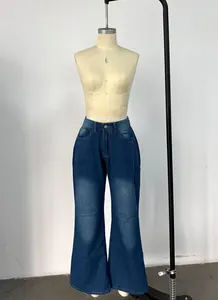 Detail shot of high-waist wide-leg jeans with vintage wash and metal button closure