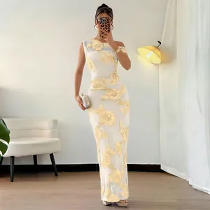 Detail of elegant white mesh dress with yellow floral embroidery and one-shoulder design