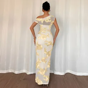 Detail of the back view showing gold floral embroidery on elegant mesh off-shoulder dress