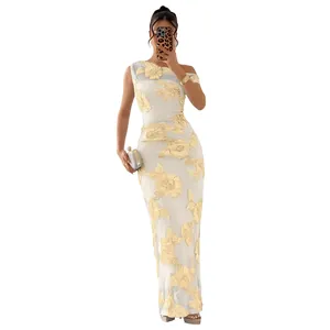 Detail of elegant white mesh dress featuring yellow 3D floral embroidery and one shoulder