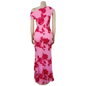 Close-up of pink mesh dress with red floral lace applique and fitted mermaid hemline