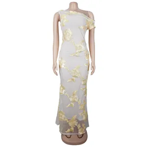 Detail of elegant white mesh dress featuring yellow floral lace embroidery and fishtail hem