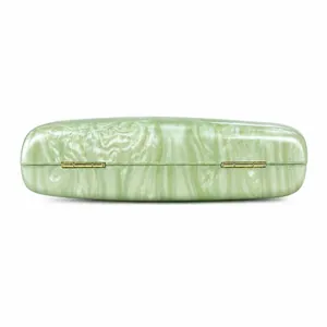 Close-up of light green marble texture acrylic material with gold metal hinges