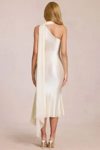 Detail of elegant satin champagne halter dress with flowing shoulder sash and fishtail hem