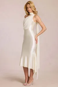 Detailed view of the creamy white satin dress featuring a draped scarf and pleated shoulder