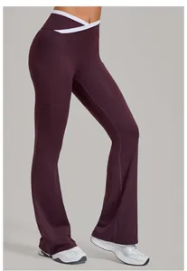 Detail of burgundy yoga flare pants featuring a white crossover V-waist and side pockets