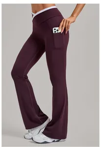 Detail showing the deep purple yoga flare pants with white cross waist and phone side pocket