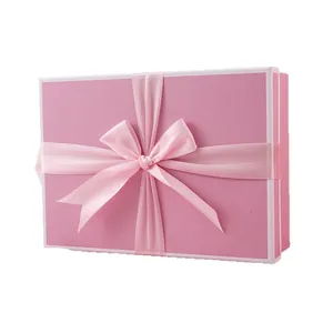 Pink rectangular matte gift box featuring a silk ribbon bow and white border accents