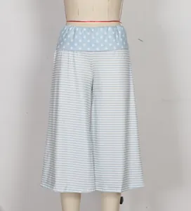 Close-up of women's lounge shorts featuring polka dot elastic waistband and striped pattern