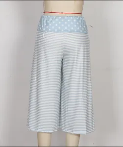 Detail of blue polka dot elastic waistband and striped pattern on summer lounge shorts