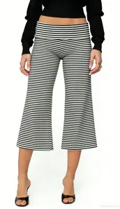 Detail of black and white striped wide-leg cropped pants with high-waisted fold design