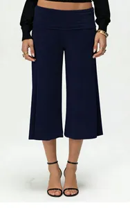 Detail view of high waist wide leg navy blue cropped trousers with folded waistband texture