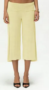 Detail view of light yellow wide-leg culottes with soft knit texture and high-waist design