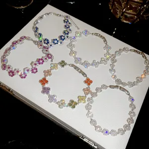 Sparkling silver flower bracelets set with colorful crystals on a white display box