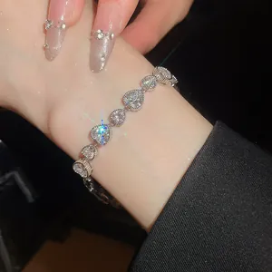 Close-up detail of elegant silver-tone bracelet featuring sparkling heart-shaped crystals
