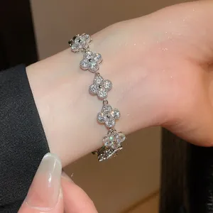 Close-up detail of a sparkling silver flower bracelet with fine crystals on a wrist.