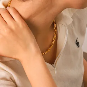 Modern gold-plated industrial link chain necklace with bead accents on model