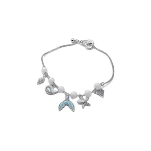 Ocean-themed zircon and cat's eye stone mermaid tail and starfish charm bracelet for women