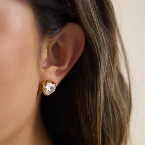 Close-up of a sparkling heart-shaped zircon stud earring crafted from gold-plated steel