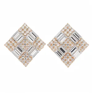 Luxurious sparkling baguette and round cut diamond rhombus stud earrings on white.