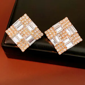 Close-up of luxury rhinestone rhombus earrings with sparkling baguette stones.