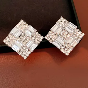 Macro detail showing the intricate baguette cut crystals on silver square earrings.