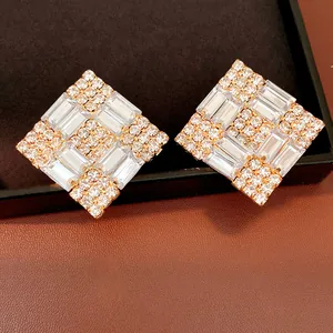 Close-up of luxury rhombus earrings with shimmering crystals and silver needles.