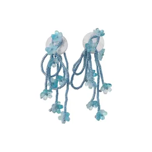 Handmade blue beaded tassel earrings with translucent flower charms for a beach vacation look