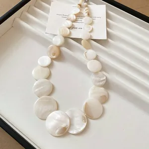 Exquisite close-up of a white shell disc choker necklace featuring natural pearl luster