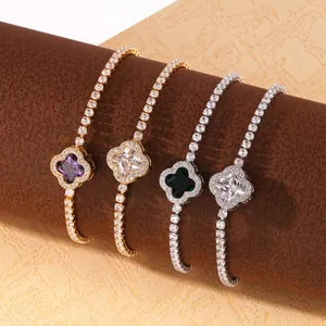 Close-up view of four elegant clover-shaped tennis bracelets with colorful gemstones on display