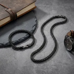 Detail view of 5mm black stainless steel wheat chain necklace and bracelet set.