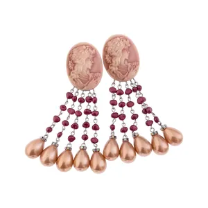 Vintage oval cameo tassel earrings with champagne pearl drops on white background