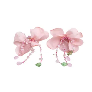 Sweet pink fabric flower earrings with crystal beaded tassels on a white background