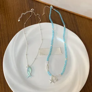 Detailed view of blue beaded ocean-themed necklace with a silver starfish pendant
