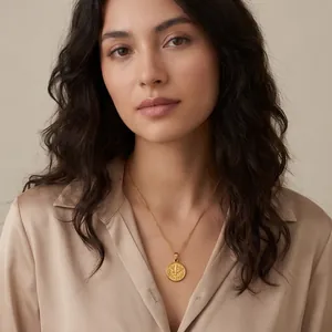European vintage 18K gold plated coin pendant necklace featuring a detailed bird pattern