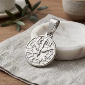 Close-up detail of a retro silver circular pendant featuring a flying bird motif