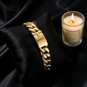 Close-up of golden Cuban link bracelet with a polished box clasp on black velvet