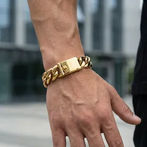 Close-up of a thick gold Cuban link bracelet for men with a secure square box clasp