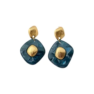 Elegant vintage geometric drop earrings with gold textured finish and teal marble resin
