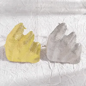 Close-up showing artistic irregular wrinkled texture joint rings in gold and silver finishes