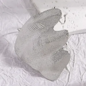 Detailed view of artistic irregular silver joint ring with unique wrinkled metal texture